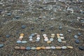 Word love made from stones on sandy beach. Royalty Free Stock Photo