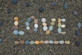Word love made from stones on sandy beach. Royalty Free Stock Photo