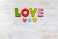 Word love made of wooden letters with hearts below on vintage wooden background. Valentines day decoration Royalty Free Stock Photo