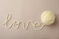 Word Love made of woolen yarn on grey background, top view Royalty Free Stock Photo