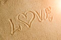 The word love is painted in the sand. Beach background. Top view. The concept of summer, summer kanikkuly, vacation, holydays