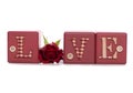 Word love with red rose