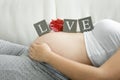 Word Love spelled on blocks on pregnant women tummy Royalty Free Stock Photo