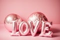 The word love spelled out of balloons in front of pink background. Generative AI