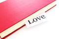 The word love sticks out of the red book Royalty Free Stock Photo