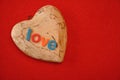 The word love on top of a wooden heart Royalty Free Stock Photo