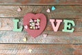 The word love from volume letters, sweet vitamins in the shape of a heart, top view Royalty Free Stock Photo
