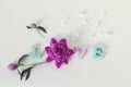 The word love from wooden letters, flowers and petals, on a light background