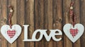 Word love in wooden letters with a white heart beside on a wooden background Royalty Free Stock Photo