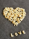 The word love in alphabet pasta with heart shape on top Royalty Free Stock Photo