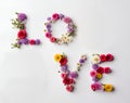 Word love written with colorful flowers.