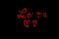 Word ` love ` written with a led lamp during a lightpainting session at night.