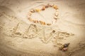 Word love written on sand at the beach, heart of shells Royalty Free Stock Photo