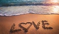 Word love written on the sand of a beach at sunset Royalty Free Stock Photo