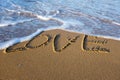 Word LOVE written on the sand at the beach Royalty Free Stock Photo