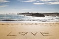 Word love written in the sand of a beautiful beach Royalty Free Stock Photo