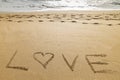 Word love written in the sand of a beautiful beach Royalty Free Stock Photo