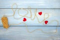 The word love is written using coarse threads and red hearts Royalty Free Stock Photo