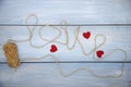 The word love is written using coarse threads and red hearts Royalty Free Stock Photo