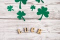 Word luck and shamrock clover leaves on a white wooden background. Happy St. Patrick`s Day. Irish holiday Royalty Free Stock Photo