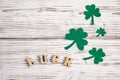 Word luck and shamrock clover leaves on a white wooden background. Happy St. Patrick`s Day. Irish holiday Royalty Free Stock Photo