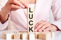 The word Luck on a wooden toy blocks with womans hands Royalty Free Stock Photo