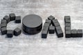 The word lumps of coal laid out on a gray background by cubes with a jar of charcoal black cream Royalty Free Stock Photo