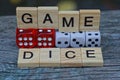 Word made of wooden letters and red and white dice Royalty Free Stock Photo