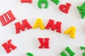 The word MAMA is made of colored magnetic letters typed by a child& x27;s hand. Mother& x27;s day. Kids love mom