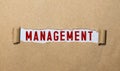 word Management on torn paper, business concept Royalty Free Stock Photo