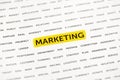 The word `Marketing` is highlighted with a marker on paper. Business concept, strategy, planning, success Royalty Free Stock Photo