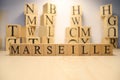 The word Marseille was created from wooden letter cubes. Cities and words.