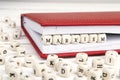 Word Marxism written in wooden blocks in red notebook on white w