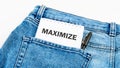 Word Maximize on a notebook on jeans on a white background Royalty Free Stock Photo