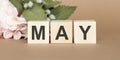 The word May on wooden cubes. Concept Month