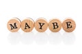 Word Maybe from circular wooden tiles with letters children toy. Royalty Free Stock Photo