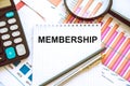 the word membership is written in a notebook with graphs beside the calculator. Member Login Membership Username Royalty Free Stock Photo