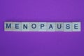 The word menopause from small gray wooden letters