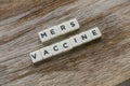 Word Mers Vaccine alphabet on wooden background
