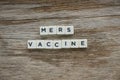 Word Mers Vaccine alphabet on wooden background