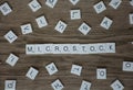 Word microstock in uppercase letters with single letters around it Royalty Free Stock Photo