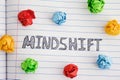 Word Mindshift on notebook sheet with some colorful crumpled paper balls around it Royalty Free Stock Photo