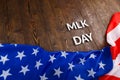 the word MLK day laid with silver metal letters on wooden surface with crumpled USA flag underneath