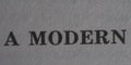 The word modern is printed on a piece of paper, close-up