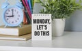 The word Monday, let`s do this concept written in a notebook with are pencils Royalty Free Stock Photo