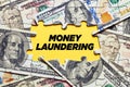 The word money laundering surrounded by puzzle pieces with dollar bills. Financial crime, corruption or fraud Royalty Free Stock Photo