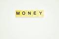 Word money. Top view of wooden blocks with letters on white surface Royalty Free Stock Photo