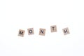 Word month arranged from wooden blocks on white background. Game