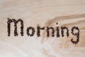 Word morning laid out from coffee grains on a wooden background Royalty Free Stock Photo