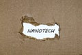 The word nanotech appearing behind torn paper